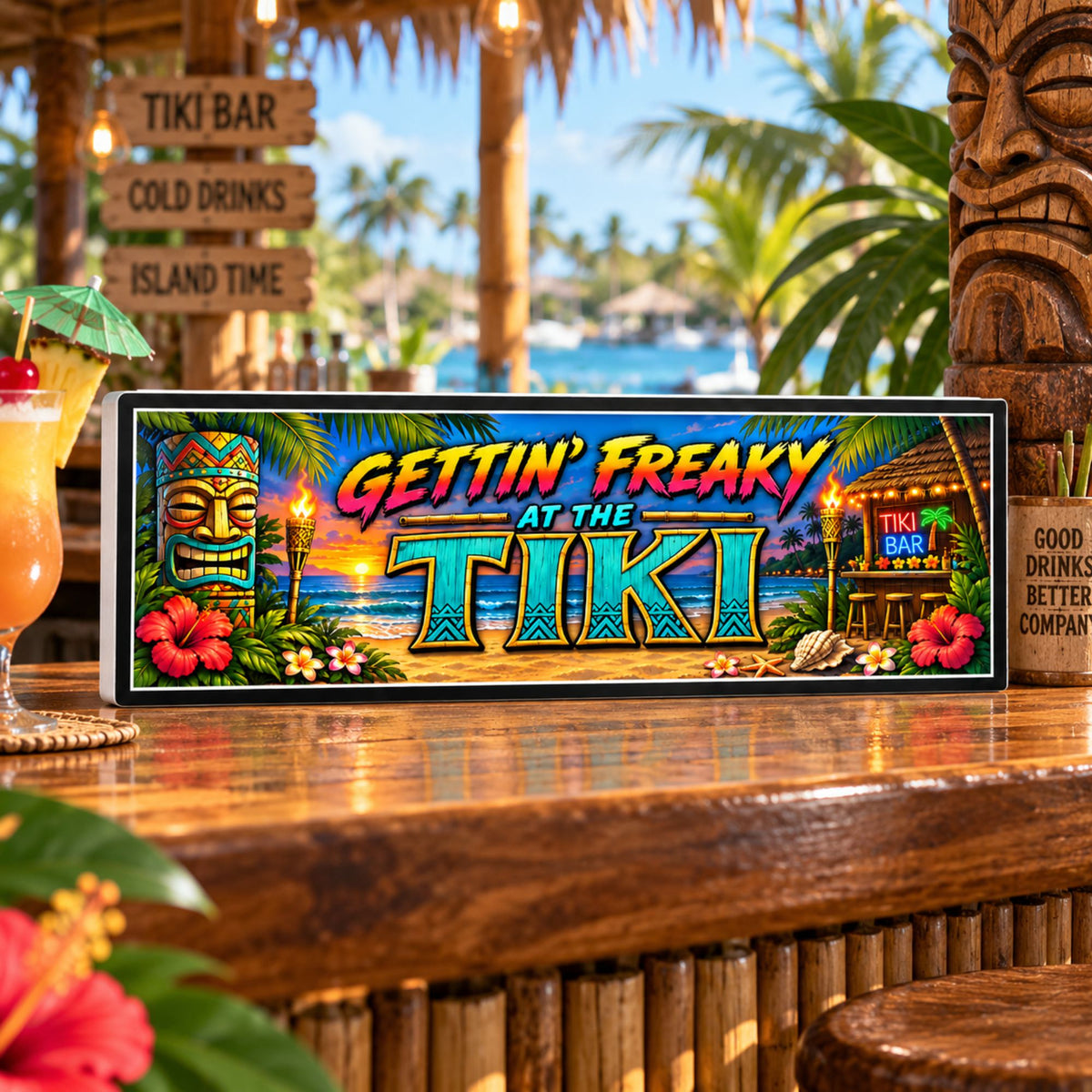 Gettin’ Freaky at the Tiki 16x5 tropical tiki bar sign displayed on an outdoor tiki bar top with palm trees, tropical decor and waterfront background.