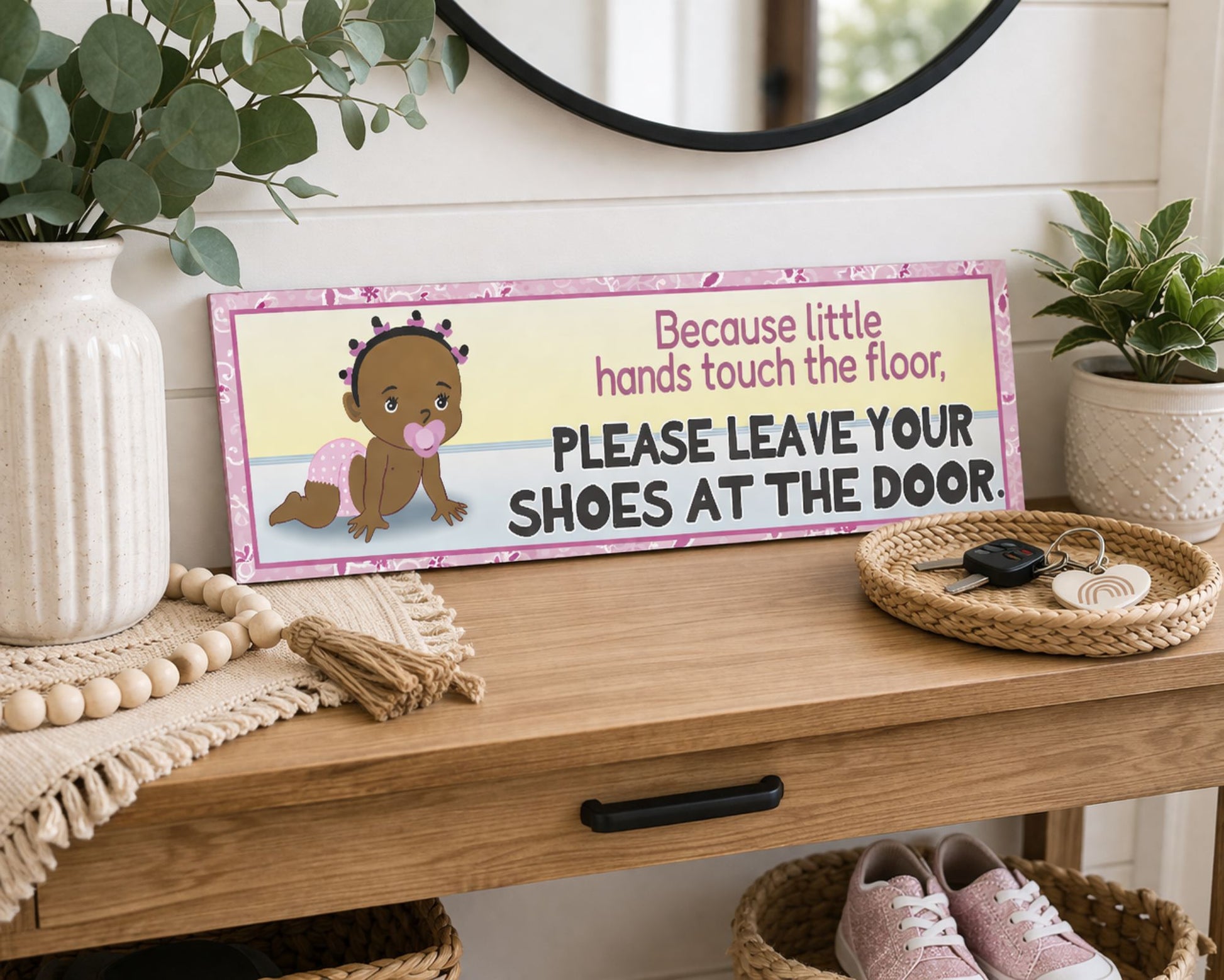 please leave your shoes at the door baby sign styled on entryway table with mirror lamp plant basket and shoes cozy home decor scene