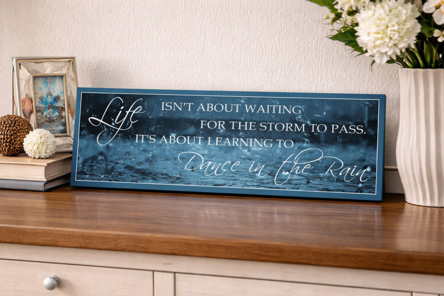 inspirational dance in the rain quote sign displayed on entryway table with decor
