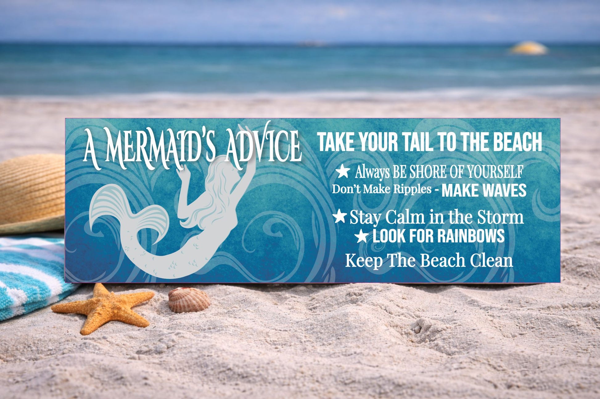 mermaid beach sign displayed on sand with ocean view coastal decor setting
