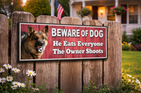 Beware of Dog sign mounted on wooden fence in front yard setting