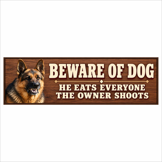 German shepherd Beware of Dog sign with a simulated woodgrain background, cream lettering, and a dark border. Wording reads “Beware of Dog — He Eats Everyone — The Owner Shoots.”