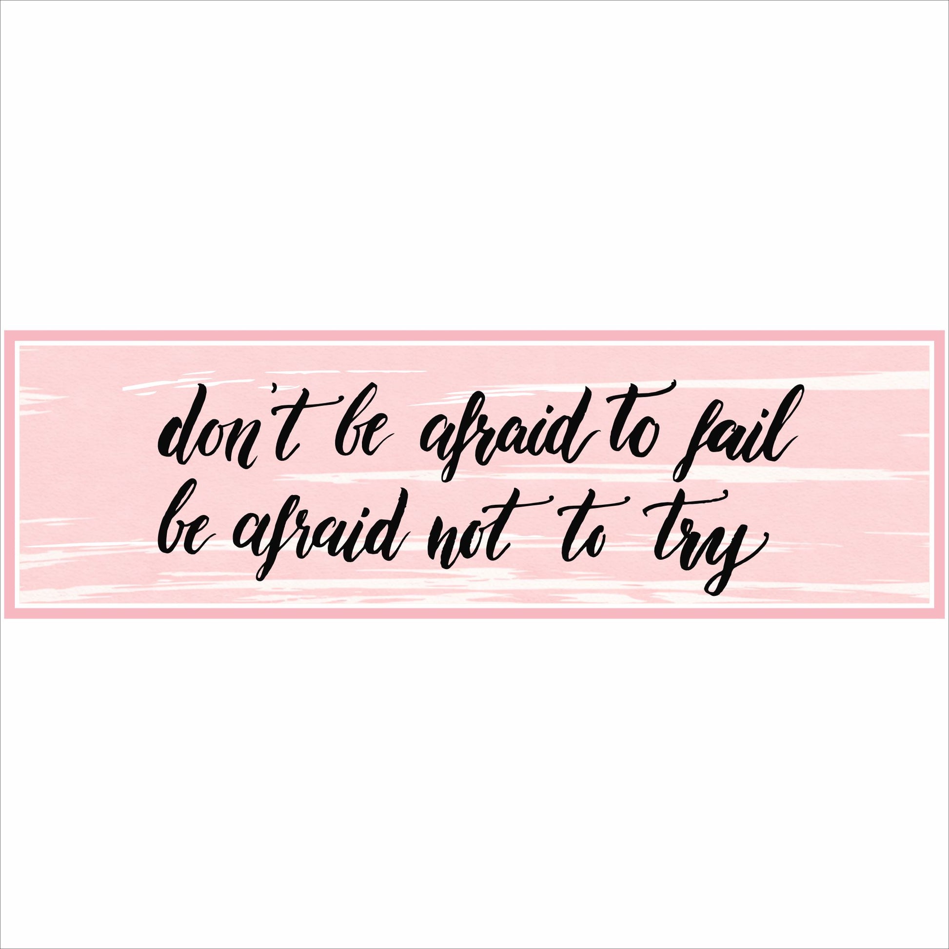 close up of pink motivational quote sign with black script text on textured background