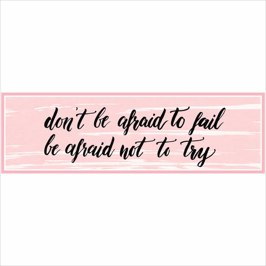 close up of pink motivational quote sign with black script text on textured background