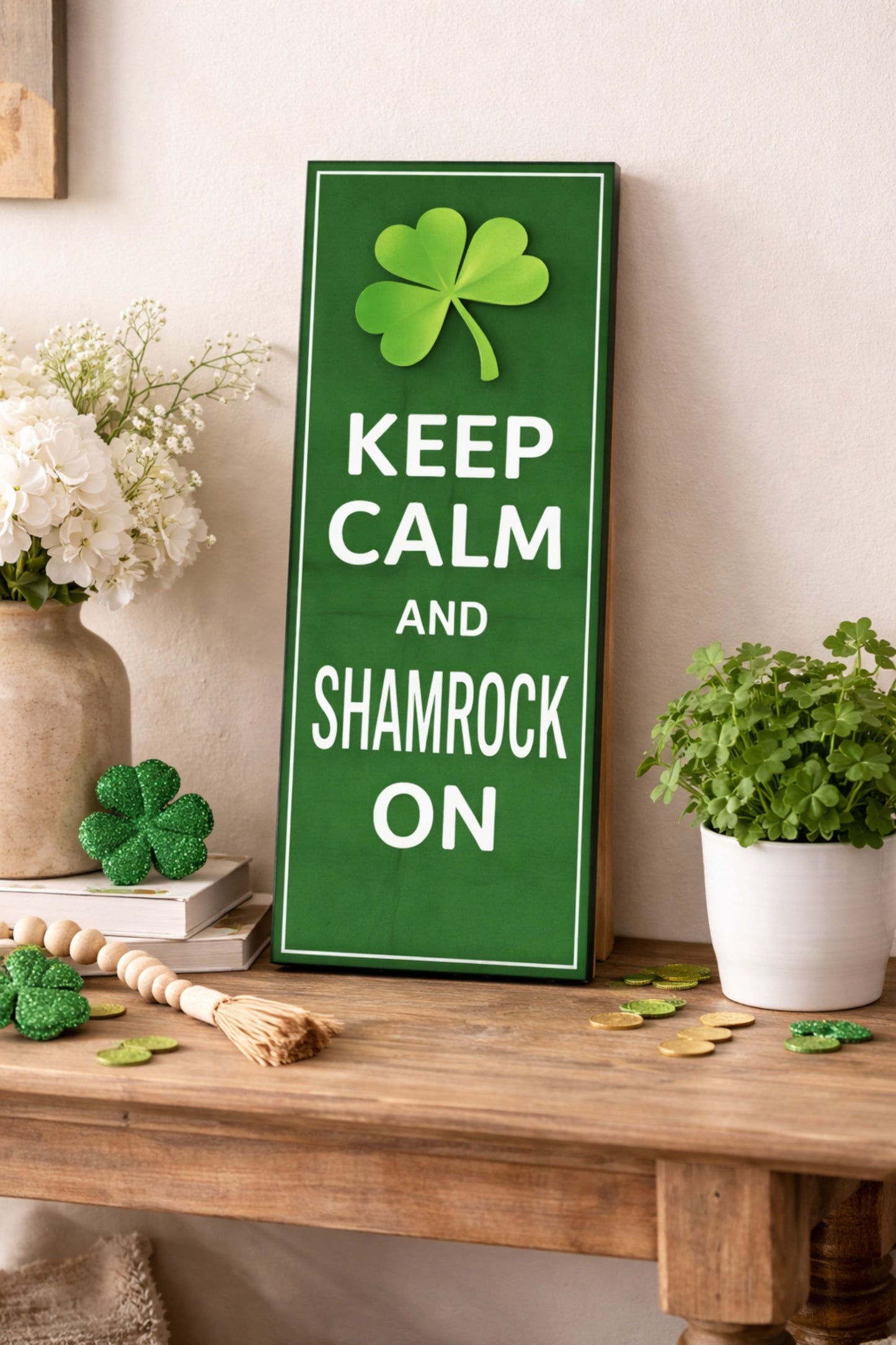 green keep calm and shamrock on sign with clover leaning on wood table