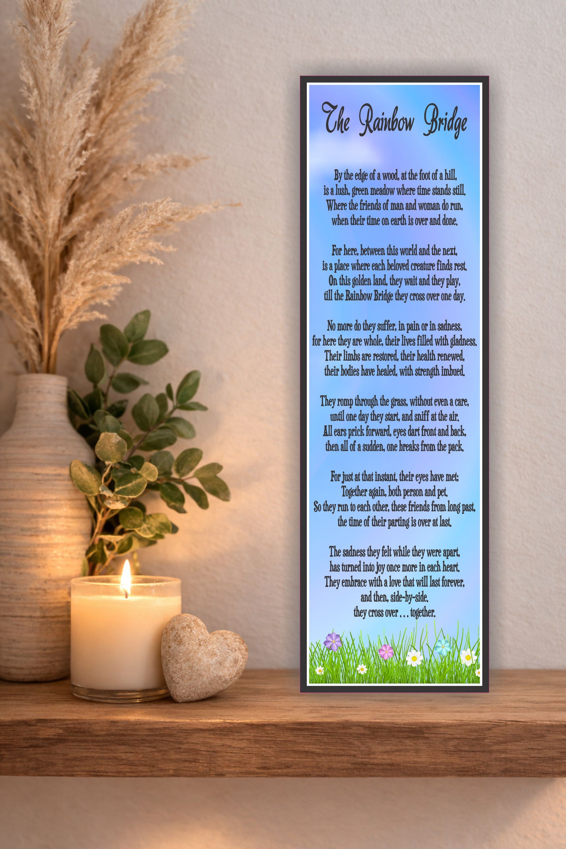 Rainbow Bridge pet memorial poem sign displayed on wooden shelf with candle and plant