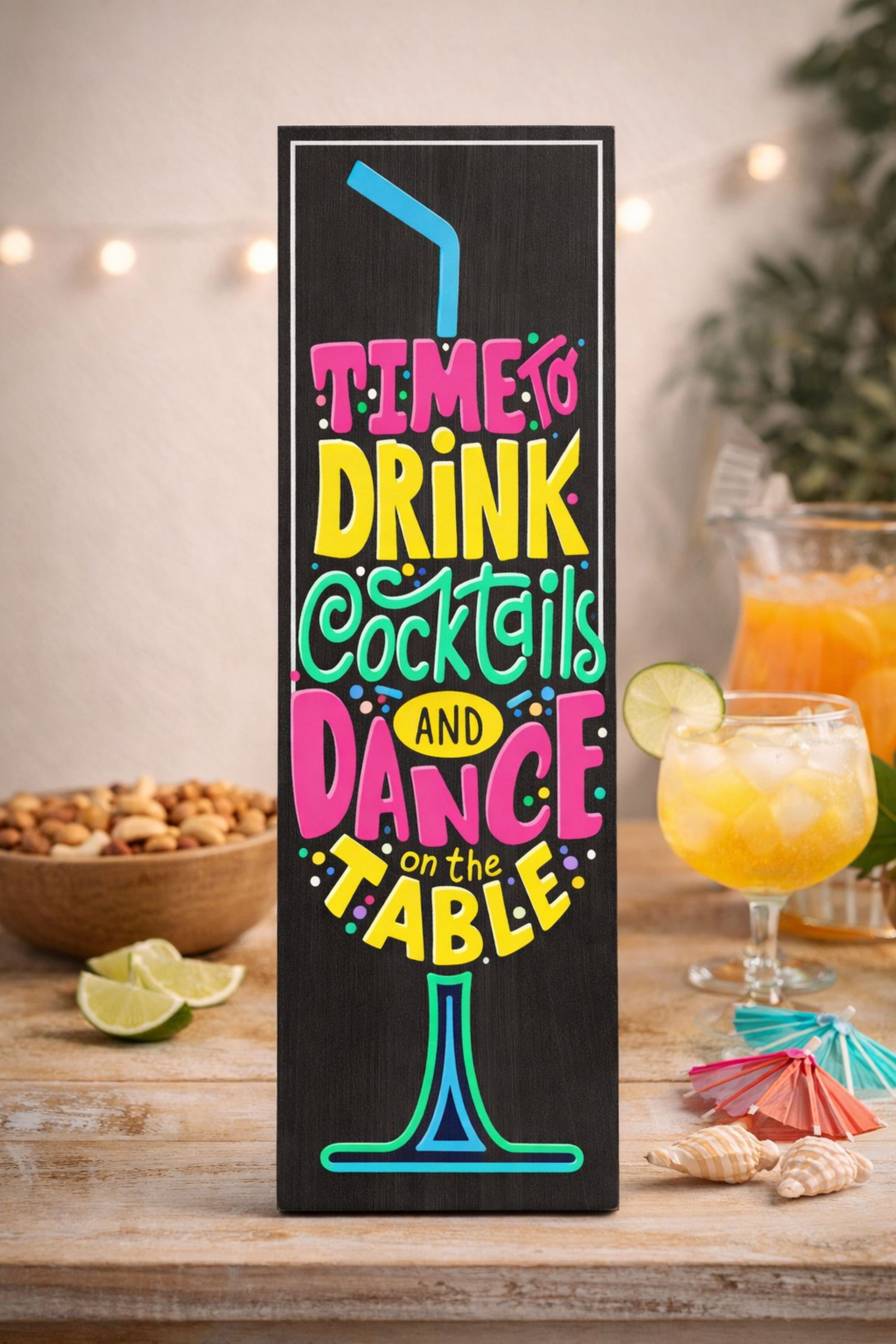 cocktail party sign styled on table with drinks lime and shells in home bar setting