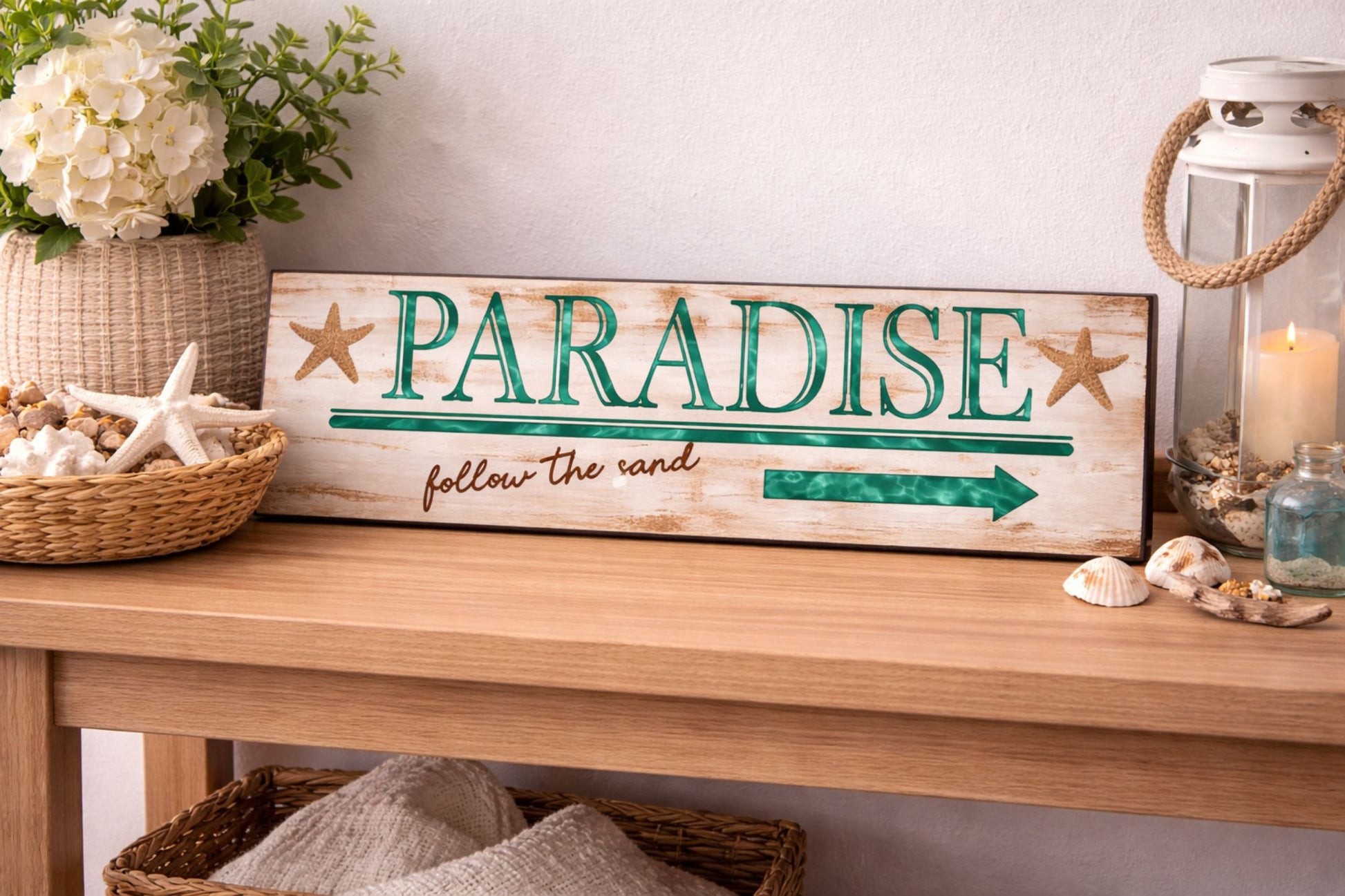 paradise beach sign on console table with coastal decor and lantern