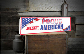  "Proud to Be An American" novelty sign with the USA flag displayed in two corners, symbolizing national pride and patriotism.