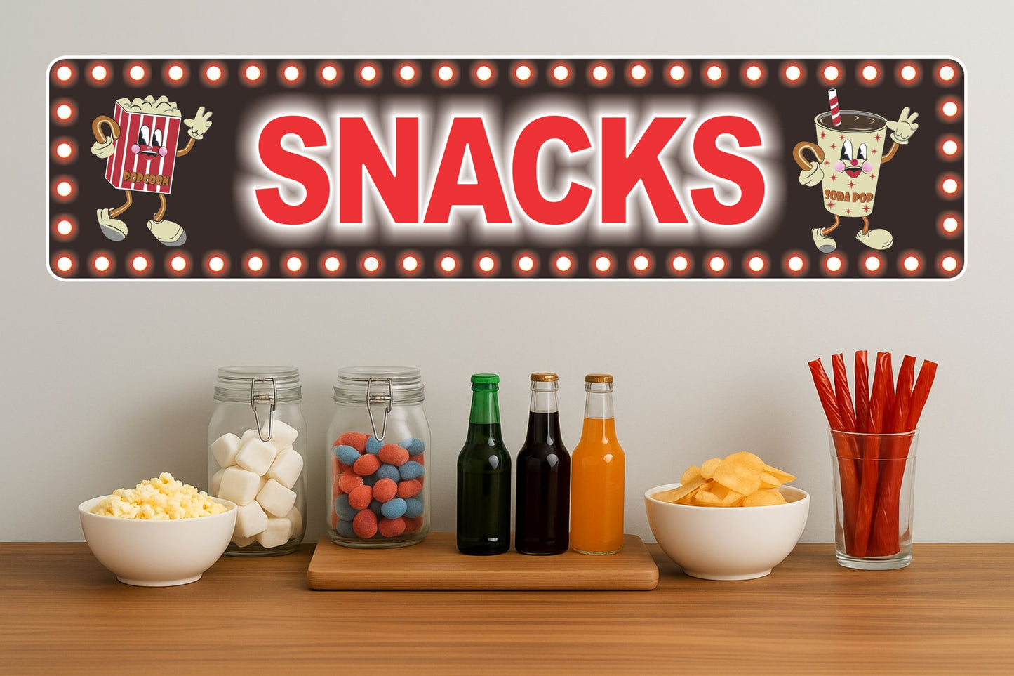 Retro snacks concession sign displayed above snacks and drinks on a counter in a home theater or game room