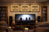 Cinema ticket wall sign displayed above a home theater setup with people watching a movie, shown for display inspiration and not to scale.