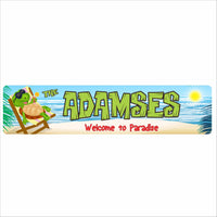 personalized beach sign with cartoon turtle relaxing in a chair and the phrase welcome to paradise on a tropical ocean background