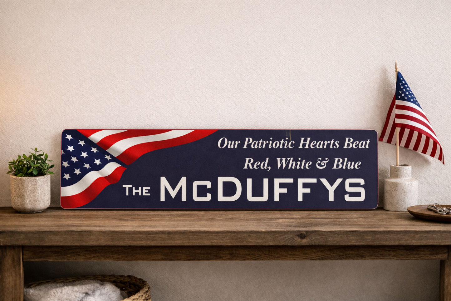patriotic metal sign on wooden console table with american flag decor and plant showing long 24x6 street sign proportions