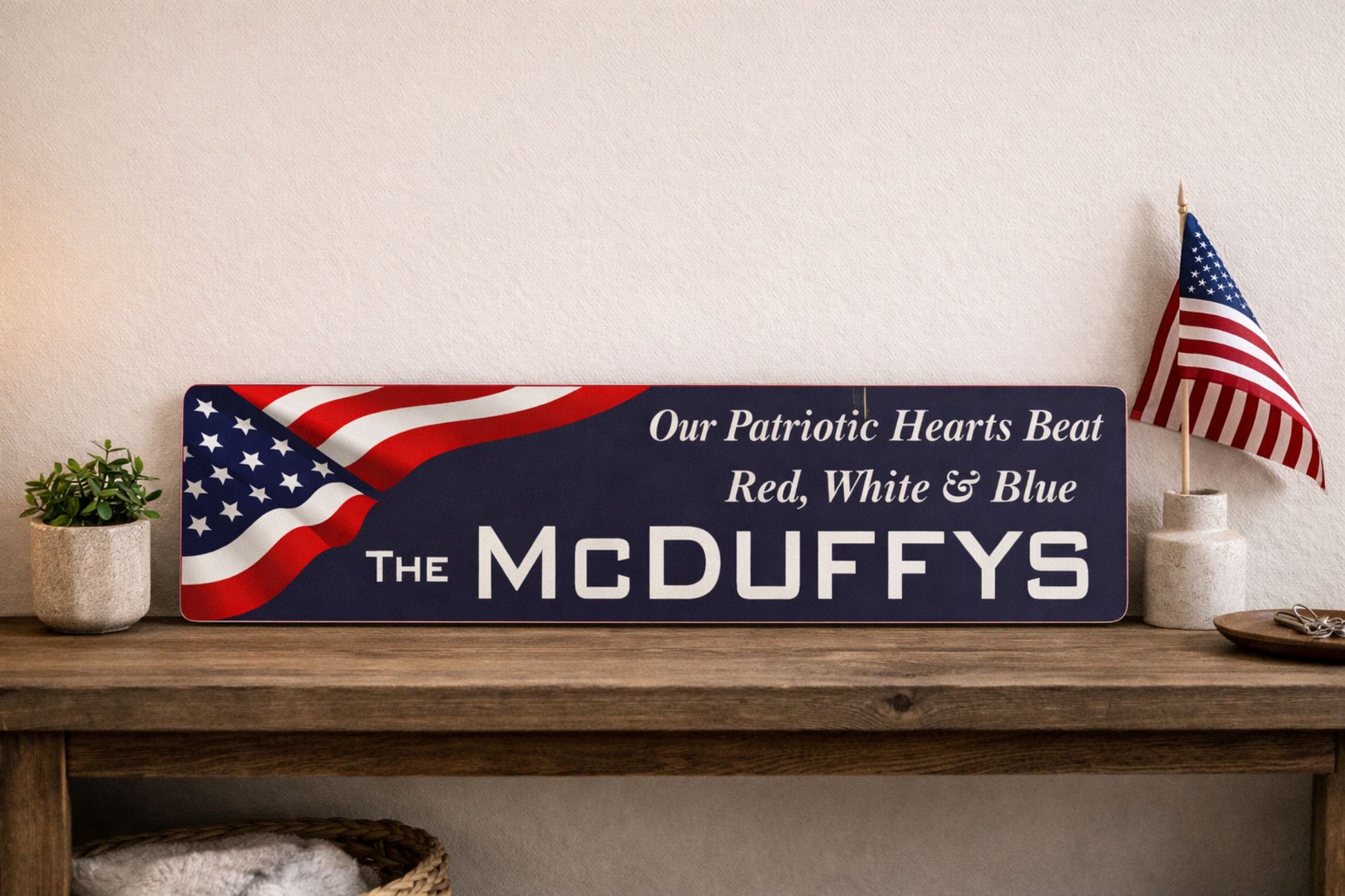patriotic metal sign on wooden console table with american flag decor and plant showing long 24x6 street sign proportions