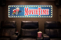 home theater room with leather recliners and a movie time marquee style sign on the wall with printed lights, popcorn and film reel artwork