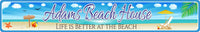 Personalized aluminum beach sign featuring an illustration of a beach with an ocean backdrop, beach chair and umbrella, sea shells, and a beach ball