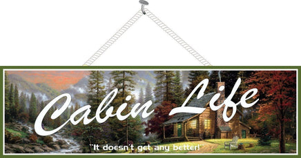 Cabin Life Rustic Wall Sign with Mountains, Trees, Stream & Cozy Log Cabin with Lights Glowing in Windows